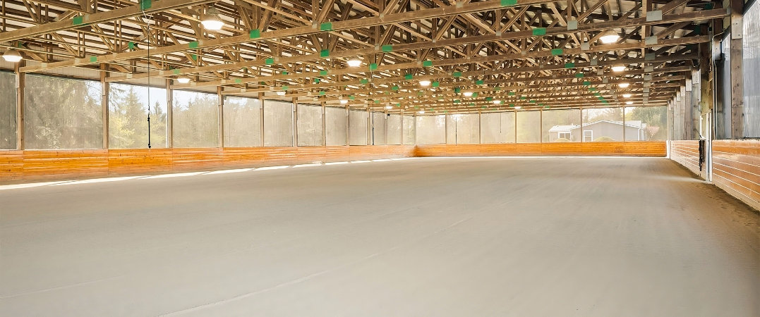 Seven Hills Training indoor mirrored riding arena with premium footing