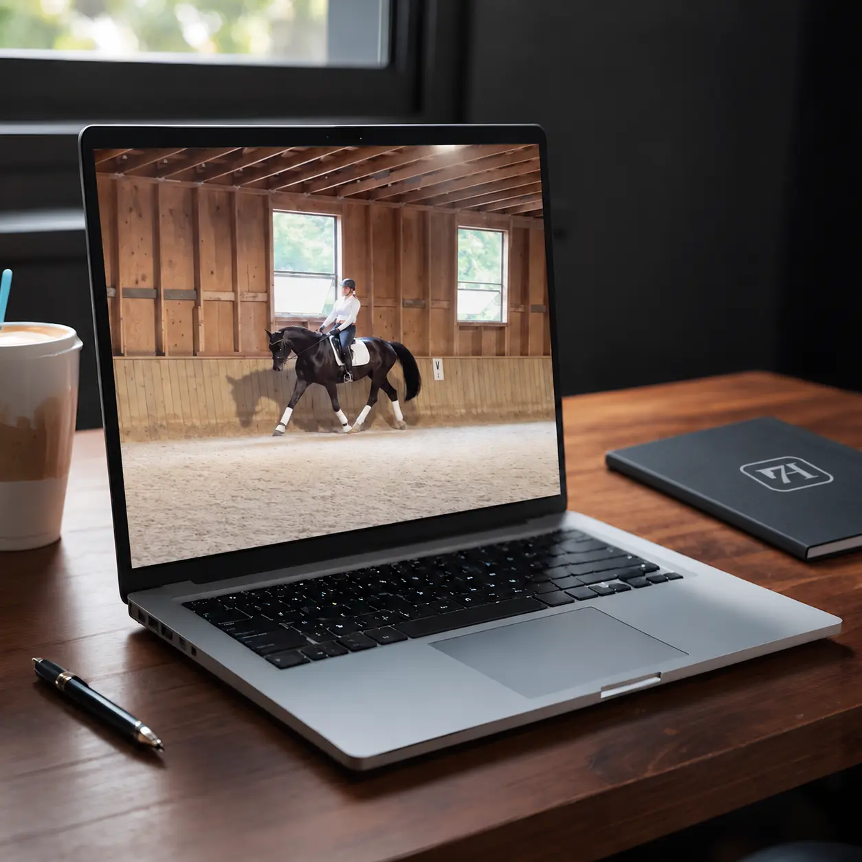 Laptop displaying a dressage ride for virtual lesson review and biomechanics assessment